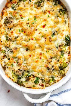 a casserole dish with broccoli, cheese and other toppings in it