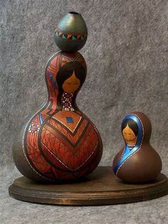 two wooden dolls sitting next to each other