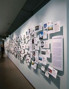 a wall covered in lots of papers and pictures