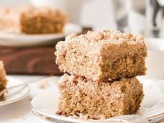 three pieces of cake are stacked on top of each other in front of the rest of the plate