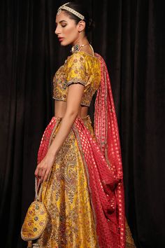 Yellow Lehenga Choli and Pink Dupatta Mehndi Dress is a traditional attire that will give you stunning attire on the big day. Lavish details of dabka kora and glamorous touch of pearls make this Pakistani Bridal Dress an epitome of beauty and your foremost priority. Bridal Choli: The choli in alluring yellow color is fully emblazoned with lavish designs and fine details of embroidery. Dabka, Kora, sitara, pearls, resham, and motifs make this choli a perfect choice to pair with the Lehenga, creat Art Silk Dupatta With Tilla For Reception, Reception Art Silk Dupatta With Tilla Detail, Navratri Salwar Kameez For Reception With Traditional Drape, Traditional Drape Salwar Kameez For Reception And Navratri, Unstitched Tilla Lehenga For Wedding, Unstitched Wedding Lehenga With Tilla Embroidery, Wedding Lehenga Unstitched With Tilla, Anarkali Traditional Wear For Reception And Festivals, Reception Lehenga With Resham Embroidery In Brocade