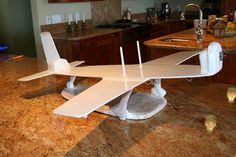 a model airplane sitting on top of a kitchen counter