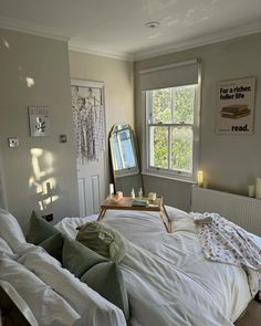 a bed sitting in a bedroom next to a window with a mirror on top of it