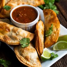 some food is sitting on a plate with dipping sauce