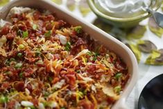 a casserole dish filled with lots of toppings on top of a table