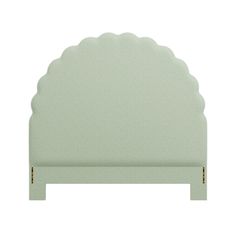 a white headboard with scalloped edges