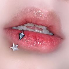 a woman's lip with a star piercing on it