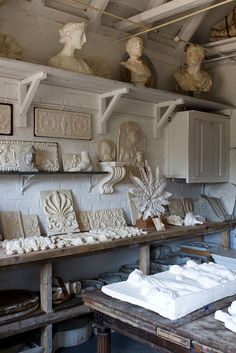 a room filled with lots of white sculptures