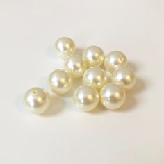 several white pearls on a white surface