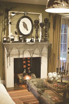 a living room filled with furniture and a fire place in front of a clock on the wall