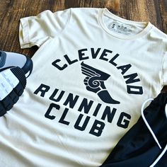 Join the Cleveland Running Club for a fun and quirky workout experience! Connect with fellow runners and explore the city while staying active. Unleash your inner athlete with this heather cream running club shirt. Designed and printed locally in Cleveland on a super soft unisex crewneck heather black tee shirt (52% cotton / 48% poly) Polyester retains shape and elasticity; Cotton lends both comfort and durability. Fits like a well-loved favorite, featuring a crew neck, short sleeves and designe 5k Shirt Design, Running Shirt Design Ideas, Marathon T-shirt, Team T Shirt Designs, Running Shirt Design, Gym Merch, Funny Running Shirts, Vintage Running, Run Club