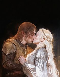 a man and woman dressed in medieval clothing kissing each other while standing next to each other