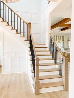 a staircase in a house with white walls and wood floors