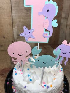 a birthday cake decorated with sea animals and the number one on it's top