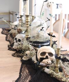 a table topped with skulls and candles