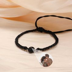 This is a mysterious bracelets, Personalized for the moment you love most on a projection bracelets! Engraved love never fades, and treasured memory will always be with you. Carry your Little cute photo hidden in the pendant, You can see the photo inside the pendant, or you can use it to illuminate the light and project your photo on the wall. The best dreamy gift for yourself and family, and friends. Customize Your Picture Projection Bracelets You can freely customize anything you like, including people, pets, scenery, and even symbol, and attach text as a souvenir. Please try to upload photos with high resolution, the higher the resolution, the more obvious the product effect. Meaningful Accessory & Memorial Gift This customized projection bracelets engraved with your favorite photo will Personalized Black Couples Jewelry, Adjustable Black Promise Bracelet, Adjustable Black Bracelet For Promise, Black Adjustable Promise Bracelet, Adjustable Black Bracelets For Anniversary, Couples' Black Promise Bracelets, Black Personalized Jewelry For Keepsake, Personalized Black Jewelry For Keepsake, Personalized Black Keepsake Jewelry