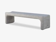 a concrete bench sitting on top of a white floor