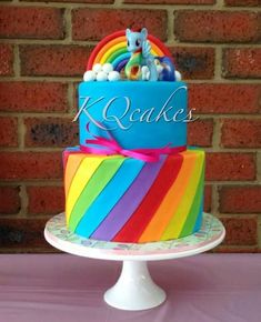 there is a rainbow cake on the table