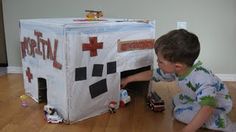 a young boy playing with a toy hospital