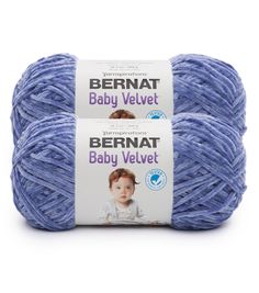 two balls of bernat baby velvet yarn in blue, on a white background