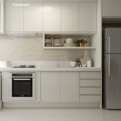 a modern kitchen with white cabinets and stainless steel appliances