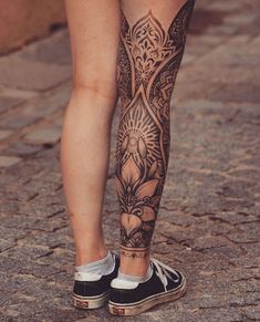 a woman's legs with tattoos on them