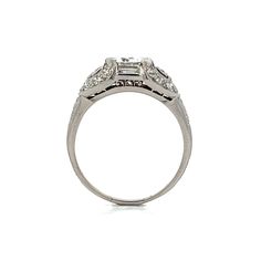 This Art Deco engagement ring features a 1.03 carat round brilliant cut diamond, graded VVS2 clarity and D color, secured in four bar prongs. The center diamond is complemented by two baguette cut diamonds and additional single cut diamonds, all G color and VS2 clarity, totaling .16 carats. The platinum band showcases intricate filigree and milgrain details, and a high-polished finish adds to its refined appearance. Ideal for those who appreciate vintage design and exceptional craftsmanship, thi Engagement Ring Style Guide, Ring Style Guide, Platinum Rose Gold, Sapphire Solitaire, Art Deco Engagement, Deco Engagement Ring, Deco Ring, Baguette Cut Diamond, Art Deco Engagement Ring