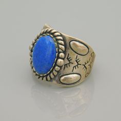 Pretty wide sterling band with southwestern designs is set with a large blue gemstone. A rope style border surrounds the pretty medium blue stone. Ring looks great on and is very comfortable when wearing. It is signed with the relios hallmark and 925 and is a US size 8. Ring measures about 3/4 inch at the widest part down the middle of the stone. Very good vintage condition - needs polishing. Now that I put it on, not sure I want to sell it but I keep too much already. Love this! Southwestern Blue Jewelry With Large Stone, Southwestern Style Blue Jewelry With Large Stone, Southwestern Blue Large Stone Jewelry, Blue Southwestern Jewelry With Concho, Bohemian Blue Rings With Concho Detail, Southwestern Blue Concho Jewelry, Southwestern Style Blue Concho Jewelry, Bohemian Blue Rings With Concho, Blue Bohemian Concho Ring