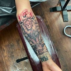 a person with a lion tattoo on their arm