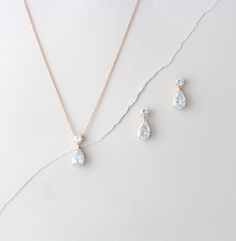 "Chic and elegant ! This set is created with rose gold finish and Premium cubic zirconia stones. A perfect selection for your bridal party or a simple set for your wedding day. Available in 2 finishes. Necklace measures 15 inches and extends to 17 inches Pendant is 7/8\" long Earrings measure 7/8\"" Gold Bridal Necklace Set, Simple Bridal Necklace, Dainty Rose Gold Necklace, Wedding Earrings Chandelier, Wedding Jewelry Sets Bridal Jewellery, Rose Gold Drop Earrings, Gold Bridal Necklace, Dainty Rose, Jewelry Rose Gold