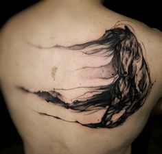 a man with a horse tattoo on his back