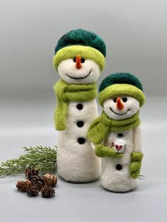 two snowmen standing next to each other