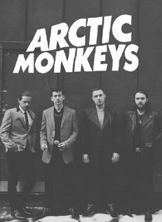 the arctic monkeys are standing in front of a building