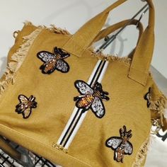 This canvas tote is embellished with the trending queen bee in Crystal. You can use this as a all day bag or it’s the perfect travel bag . It has a zipper closure. A large inside zipper pocket for storage. 17L X 12H X 6W Trendy Embroidered Canvas Bag For Travel, Bee Bag, Bee Bag Crochet, Bumble Bee Handbags, Perfect Travel Bag, Owl Tote Bag, Day Bag, Queen Bees, Zipper Pocket