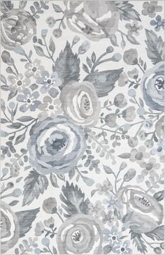 an area rug with blue and gray flowers on the ground, in front of a white background