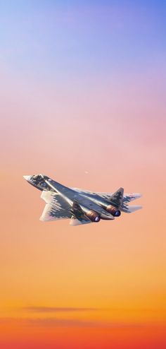 a fighter jet flying in the sky at sunset