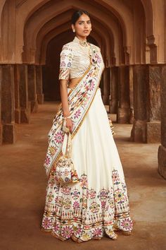 Ivory silk lehenga with floral motifs highlighted in sequin and mirror work. Paired with blouse and silk dupatta in zari, gota, sequins, resham and mirror work.
Component: 3
Pattern: Embroidered
Type Of Work: Zari, Gota, Sequins, Resham and Mirror
Neckline: Round
Sleeve Type: Short Sleeves
Fabric: Silk
Color: White
Other Details: 
Floral motifs
Back tassel tie-up
Note: Neckpieces and potli bag shown in the image is not for sale
Occasion: Sangeet, Destination Wedding - Aza Fashions Mayyur Girotra, Unique Bridesmaid Dresses, Unique Bridesmaid, Bridal Lehengas, Silk Lehenga, Chaniya Choli, Designer Gowns, White Silk, Bridal Lehenga