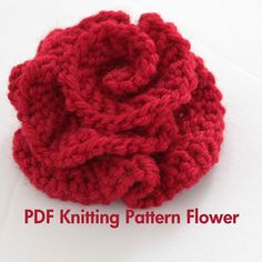 a crocheted red flower sitting on top of a white table next to text that reads, pdf knitting pattern flower