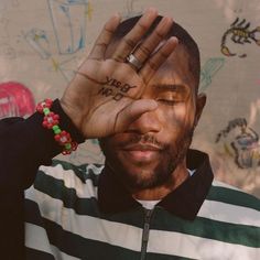 a man holding his hand up to his face with the word sorry no written on it