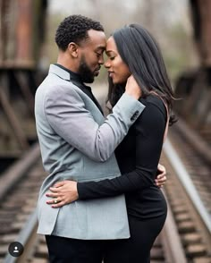 a man and woman embracing each other in front of train tracks with the caption instagram