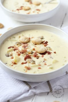 two white bowls filled with food on top of a table