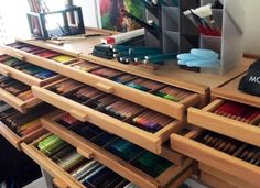 the drawers are filled with many different colored pencils