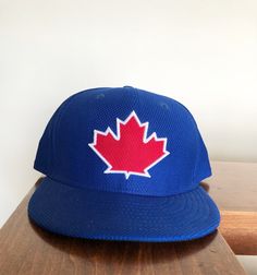 New Era Fifty Nine Fifty Toronto Blue Jays Fitted Hat size 7 1/2. This is a great looking hat that is different from the normal New Era's. It is unique, great color and awesome design. Blue Fitted Baseball Cap For Baseball Season, Blue Flat Cap For Baseball Season, Blue Fitted Hat With Flat Brim For Baseball Season, Blue Flat Brim Fitted Hat For Baseball Season, Blue Flat Brim Fitted Hat For Fan Gear, Adjustable Blue Flat Cap, Blue Adjustable Flat Cap, Blue Snapback Fitted Hat For Baseball Season, Blue Flat Brim Baseball Cap For Baseball Season