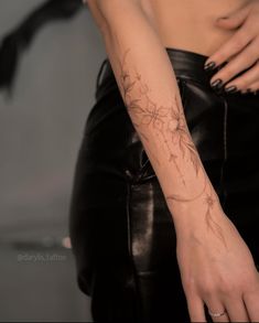 a woman's arm with flowers on it