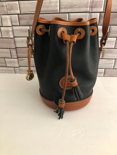 Vintage Donney & Bourke all weather leather black Drawstring Cross body bag . per-owned Condition  .  Please Review Photos For More Detail. Measures: 9" x  8" x  6.5" . Adjustabl  strap drop   22"  adjustable . Comes with hang tag .