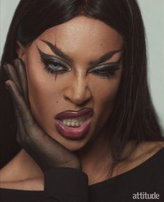 a woman with black makeup and dark make - up