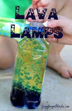 a bottle filled with liquid sitting on top of a cement floor next to a child