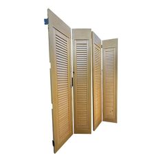 three open wooden doors with shutters on each side