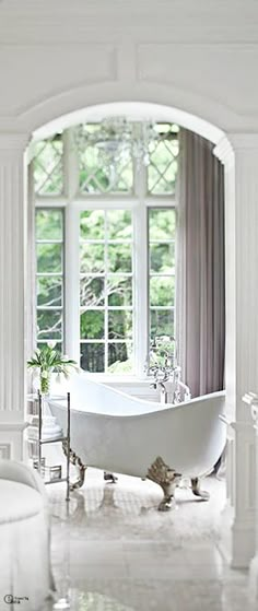 a white bath tub sitting next to a window