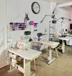 a room with several sewing machines and desks